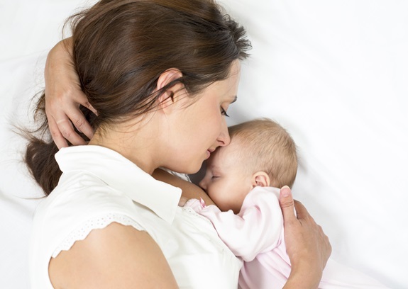 Woman laying with baby