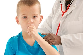 boy coughing into hand while doctor holds his back