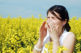 Woman with allergies in a field