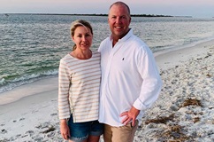 Penn Medicine bariatrics patient Neil Scott stands with his wife on the beach