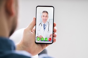 Person using phone to talk to provider face to face (telemedicine)
