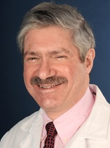 headshot of Alain H. Rook, MD