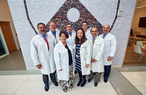 Physicians Standing In Front of Penn Logo