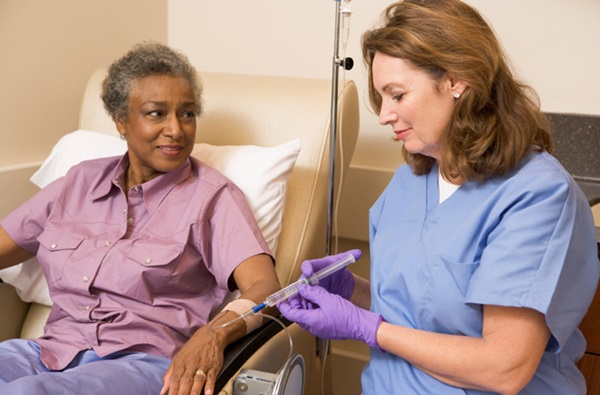 Nurse giving patient chemotherapy