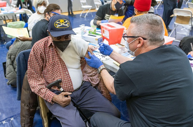 Elderly Black man receiving the COVID vaccine at West Philly community vaccine clinic 