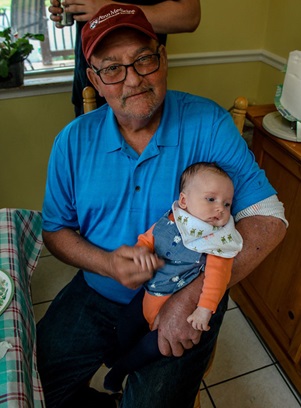 Myelodysplastic syndrome (MDS) survivor Craig Super holding grandchild