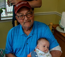 Myelodysplastic syndrome (MDS) survivor Craig Super holding grandchild