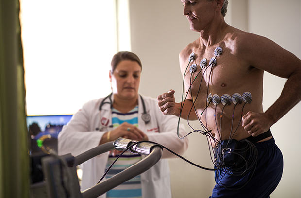 patient running on a treadmill with an EKG on