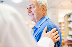 Doctor Comforting  Older Male Patient