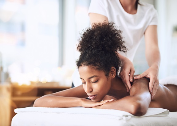 woman lying on table enjoying a massage