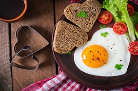 eggs and toast shaped like hearts on a plate