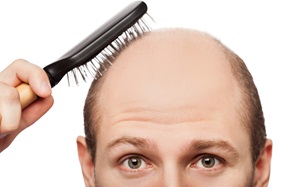 balding man brushing hair
