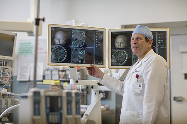 Brain Tumor Center-Dr. Steven Brem Looking at Brain Tumor Scans 
