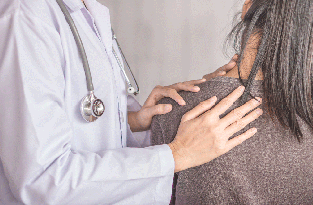 Provider holding patient's shoulder while patient holds neck