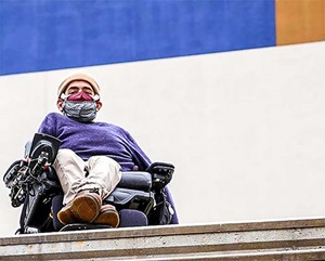 young man in wheelchair and face mask
