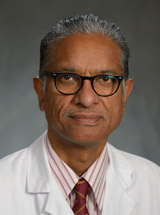 headshot of Kumarasen Cooper, MD, MBChB, DPhil