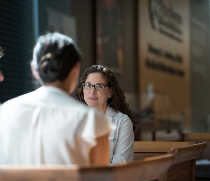 two doctors chatting on a bench