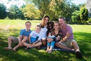 Jason and Alicia Taylor sitting on the lawn with their children, Grace, Gavin and Wyatt.