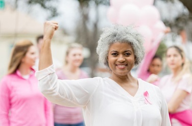 breast cancer survivor flexing muscles