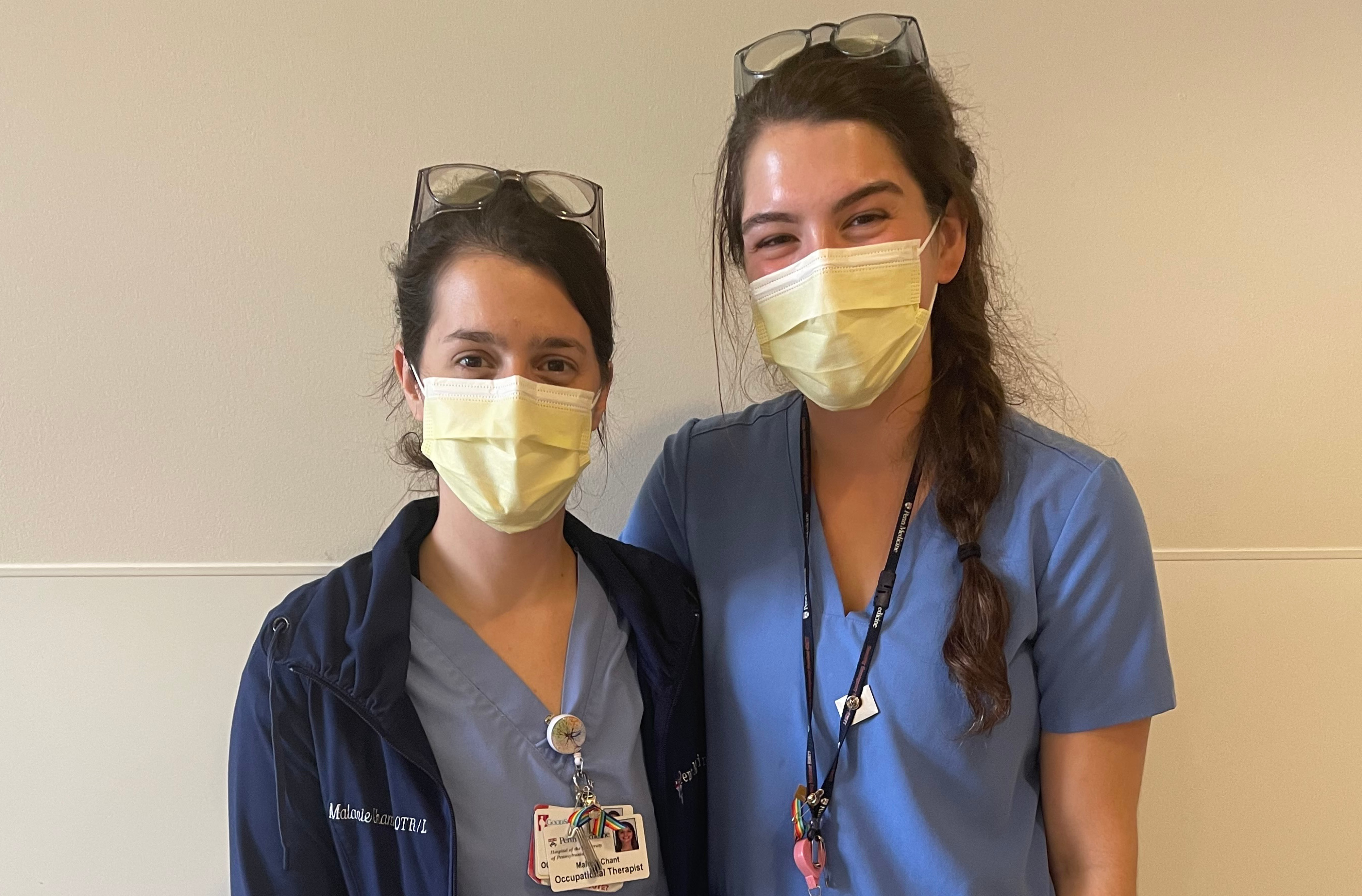 Occupational therapist Malarie Chant (left) and physical therapist Dayna Brooks stand side by side wearing hospital scrubs.