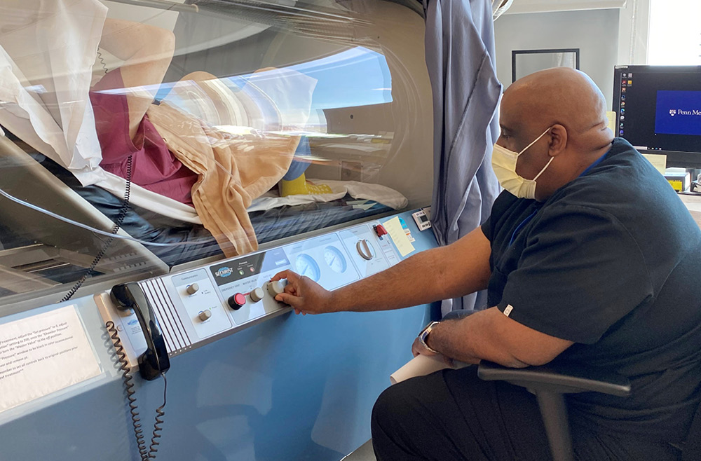 Reginald Boigris treating a patient in the Hyperbaric Oxygen Chamber