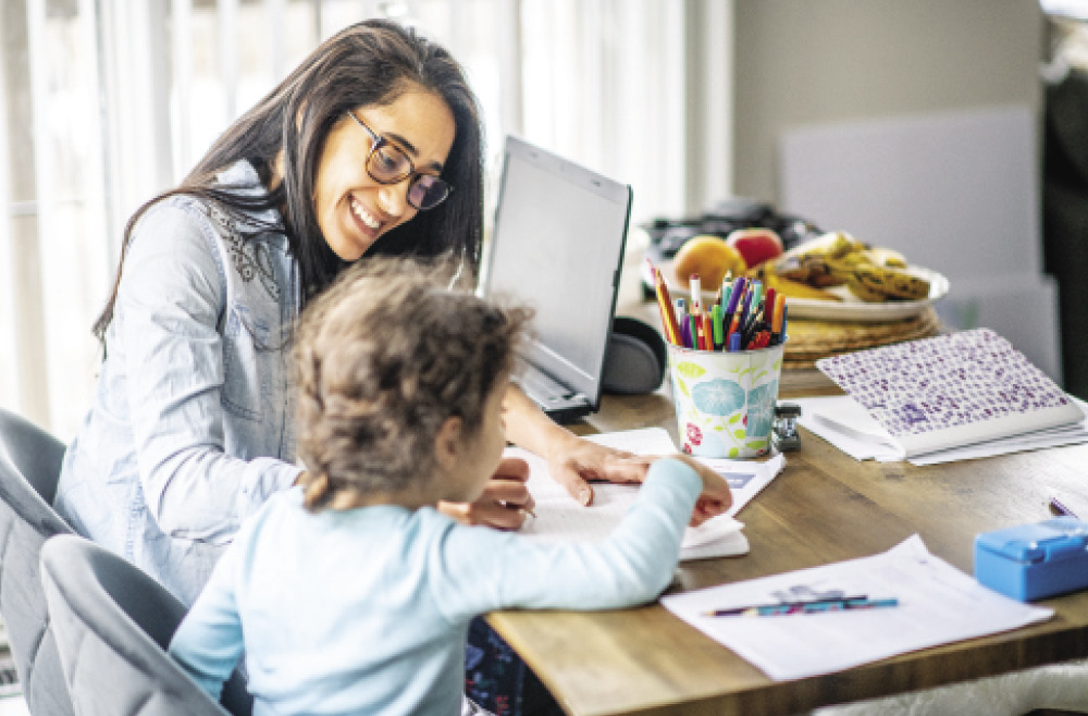 Parent working remotely helping child with school work
