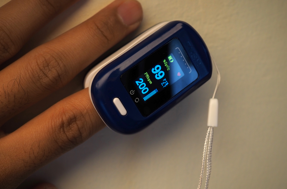 Close up image of a pulse oximeter on a person's finger